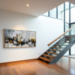 Golden Faultline abstract painting displayed beside a modern glass-and-wood staircase