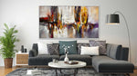 Contemporary abstract canvas above dark grey corner sofa